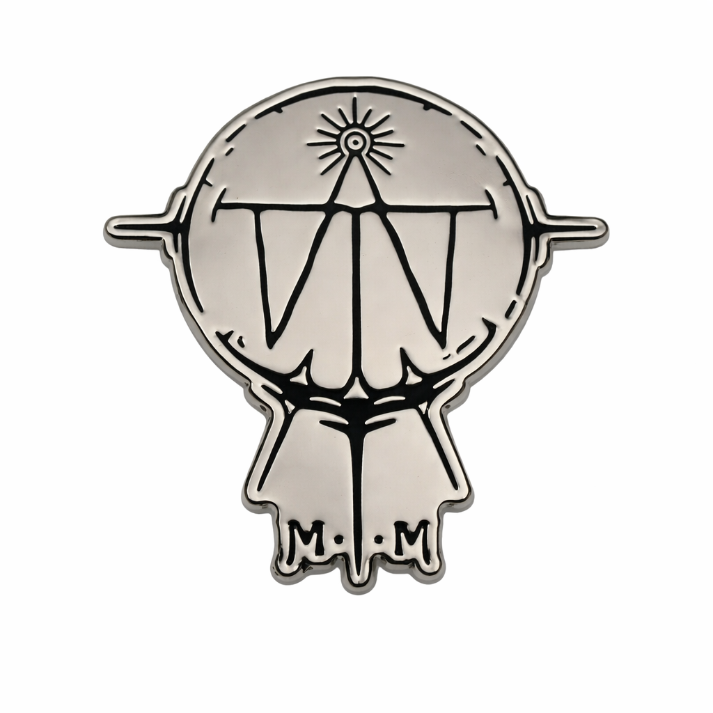 Metallic emblem with a design and 'M.M' initials on a white background