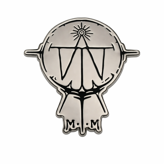 Metallic emblem with a design and 'M.M' initials on a white background